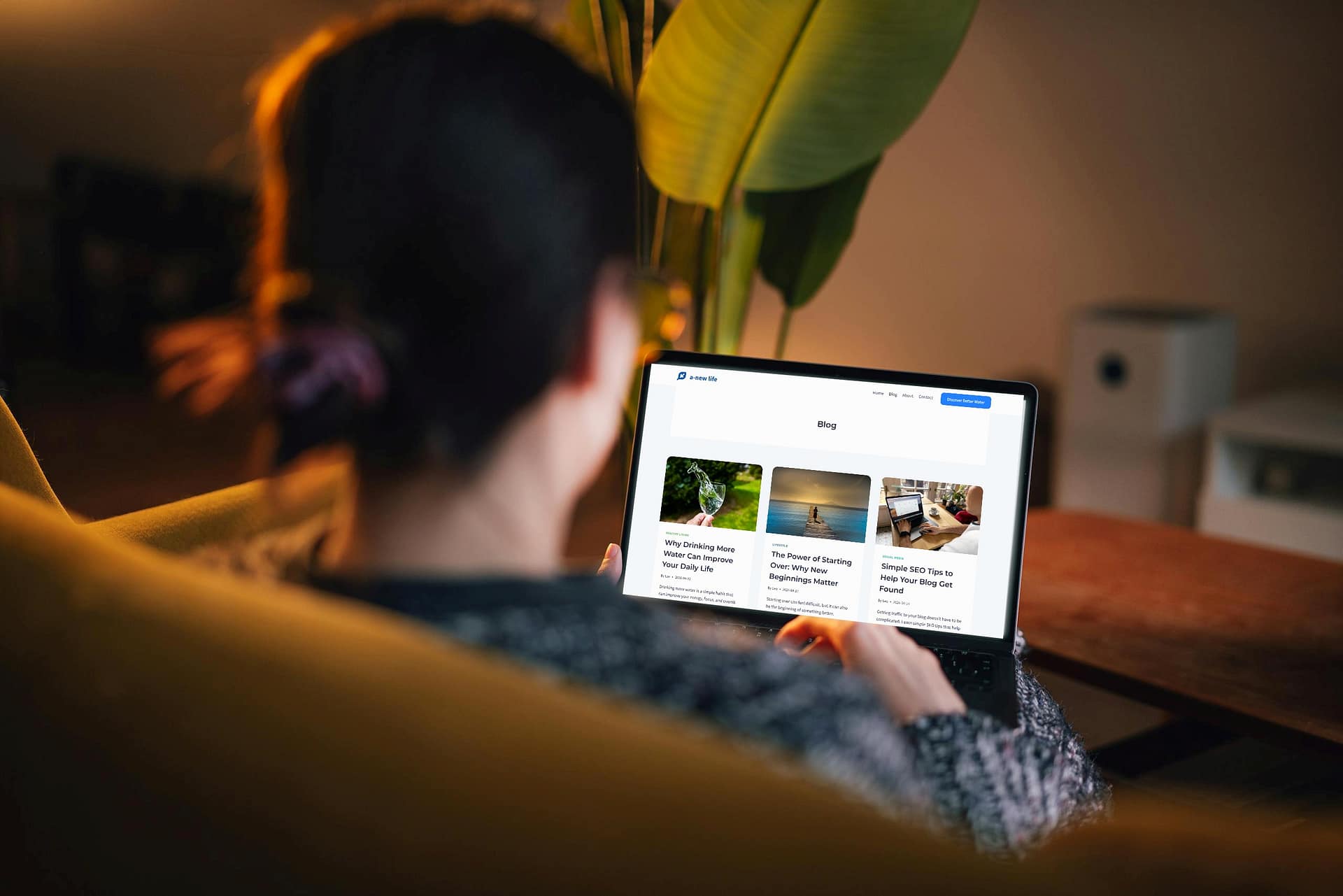 Woman reading blog content on a laptop in a calm setting.